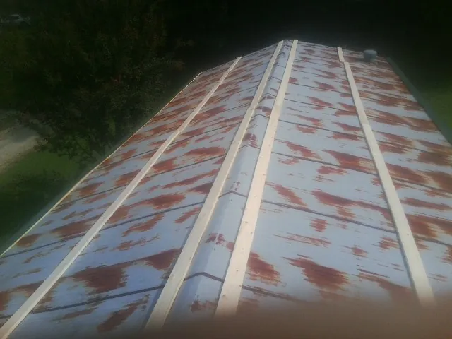 Rusted metal roof panels with new wood purlins before replacement — Storm Damage Roof Repair in Mekinock by Roofing Brothers