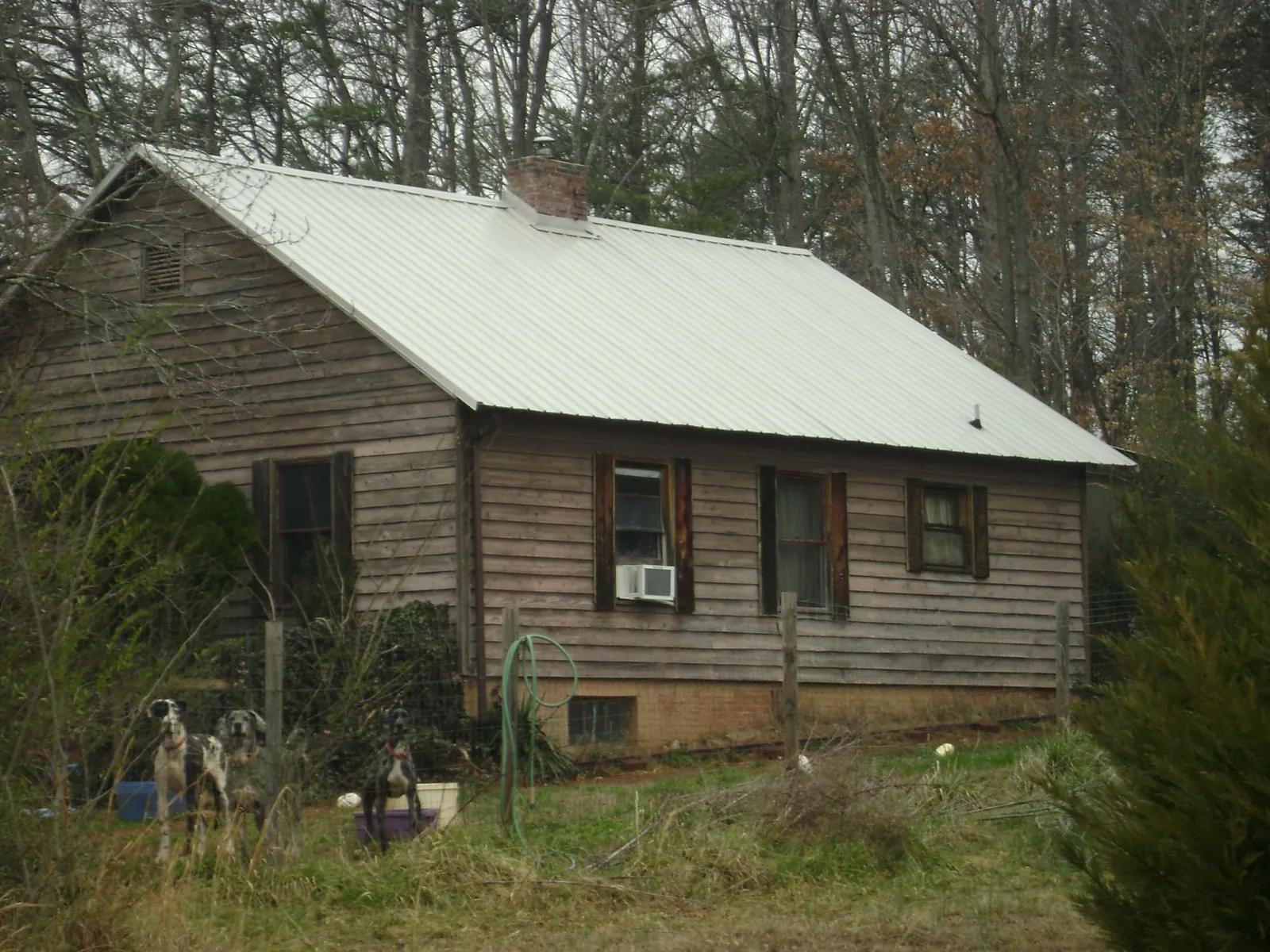 White metal roof on an old wood sided farmhouse, from a Metal Roof Installation job in Mekinock